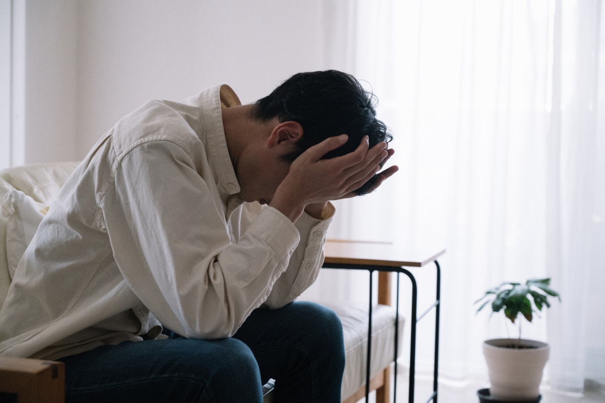 男性　俯く　リビング